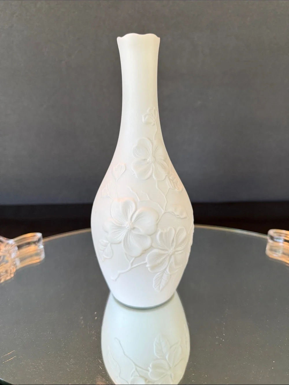 AK Kaiser White Bisque Porcelain Bud Vase featuring an embossed floral design.